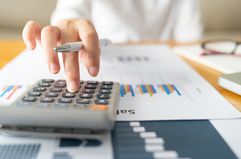 A business woman using a calculator.