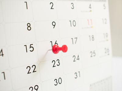 Close-up of a calendar with a pin on a date