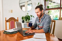 A business man in casual wear taking a cryptocurrency trading courses.