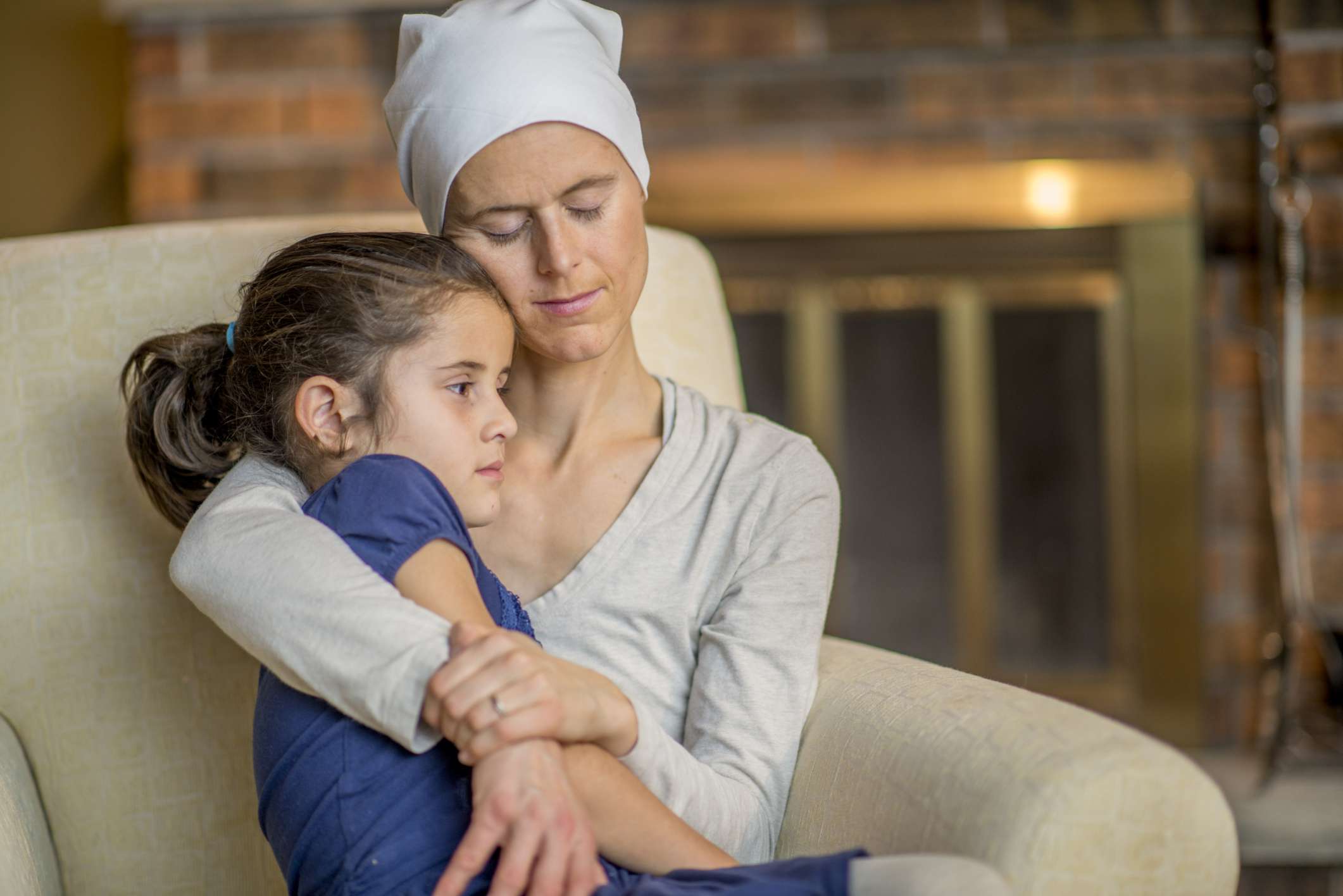 A mother with cancer holding her daughter.