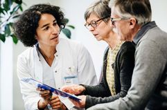 Clinical Doctor Giving Test Results To Patients