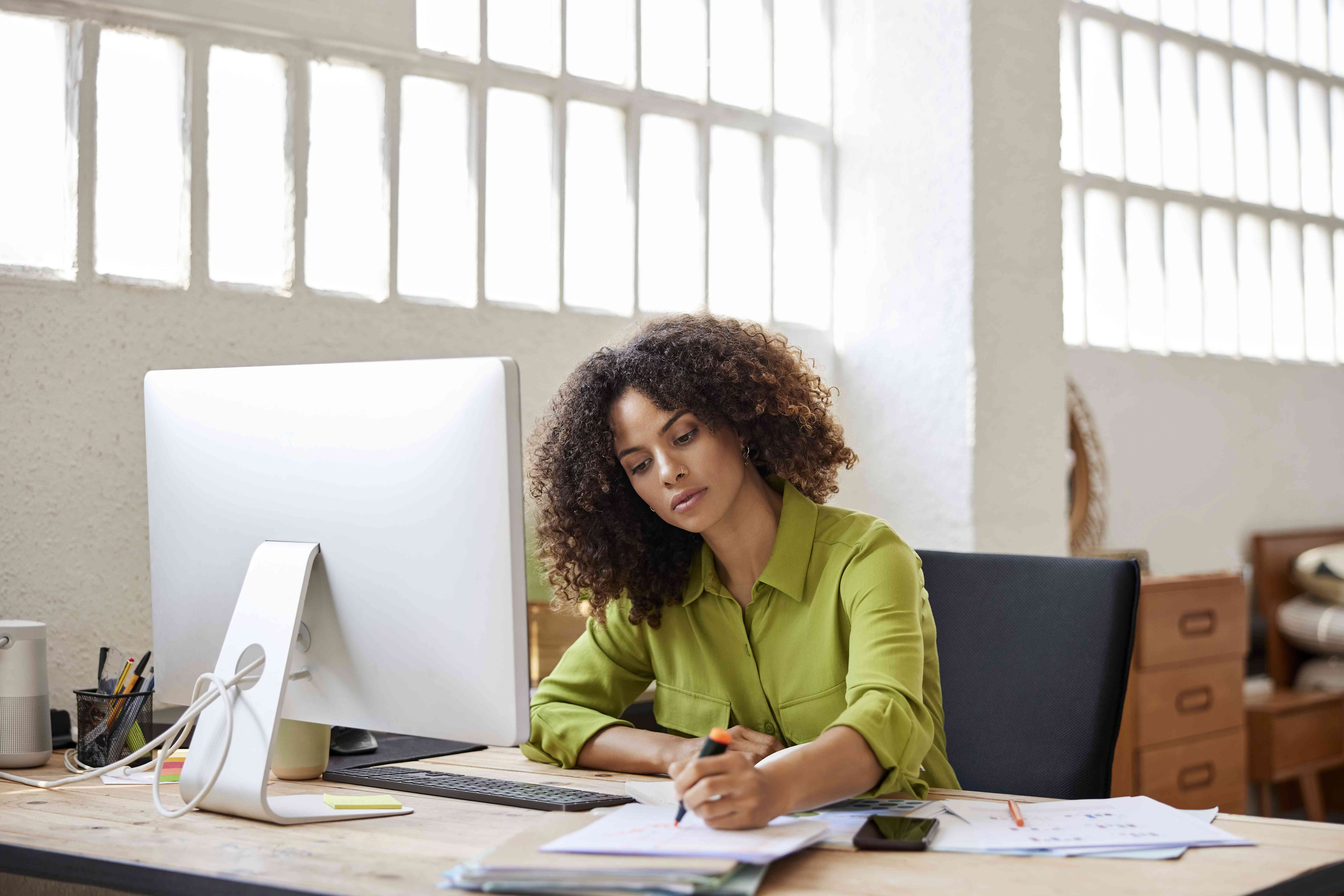 A woman drafts a document.