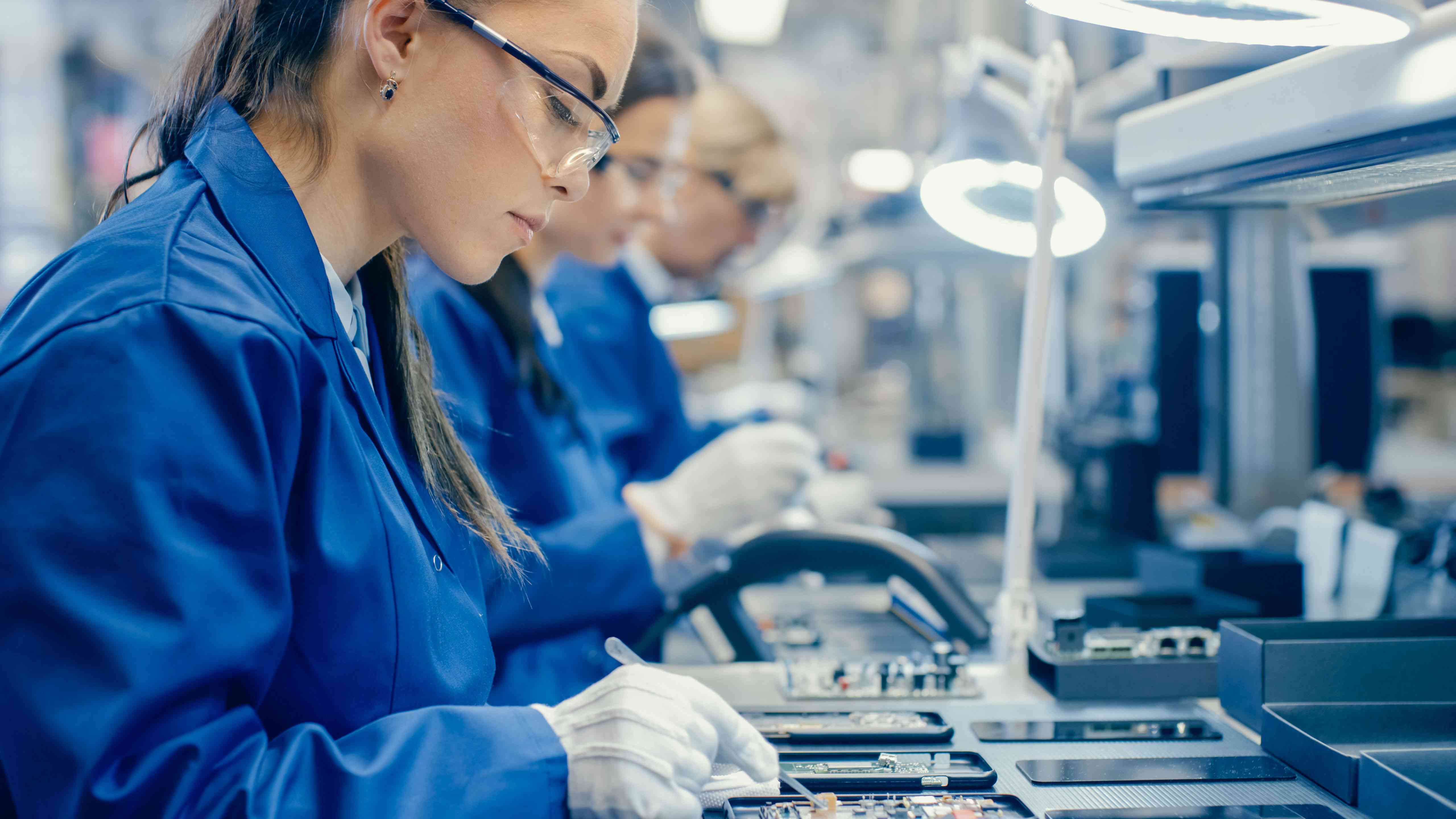 Workers in a factory assembling smartphones