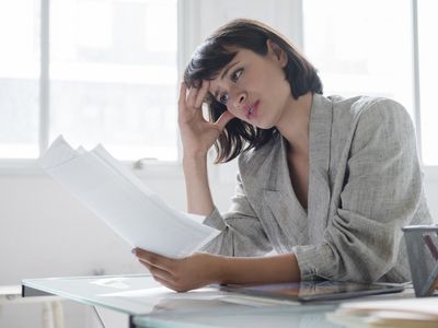 Businesswoman reading papers