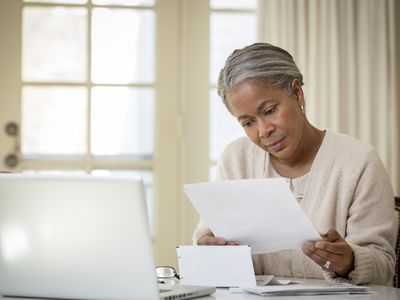 Woman reviews documents at a desk. 