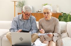 Couple pays bills in living room