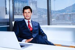 businessman sitting in front of a desk in the office.