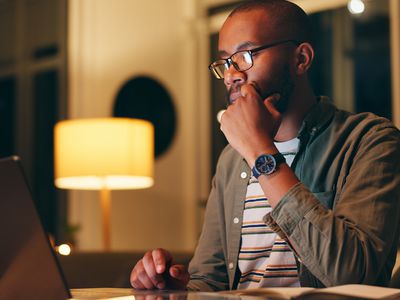 Man working on laptop at night