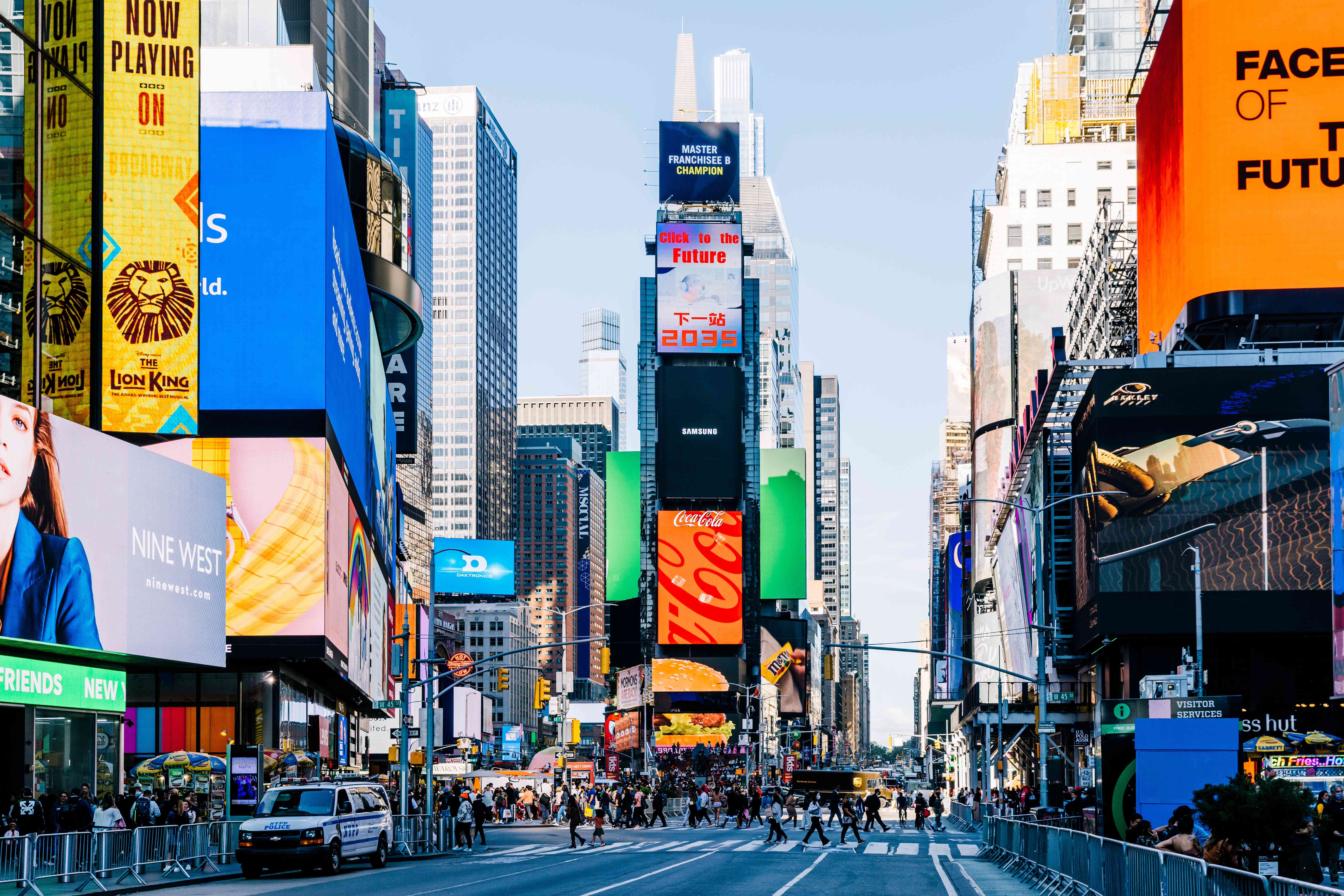 LED screens and billboards on Times Square on a sunny day, New York, USA