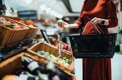 Cropped shot of young Asian woman carrying a shopping basket, grocery shopping food liability insurance