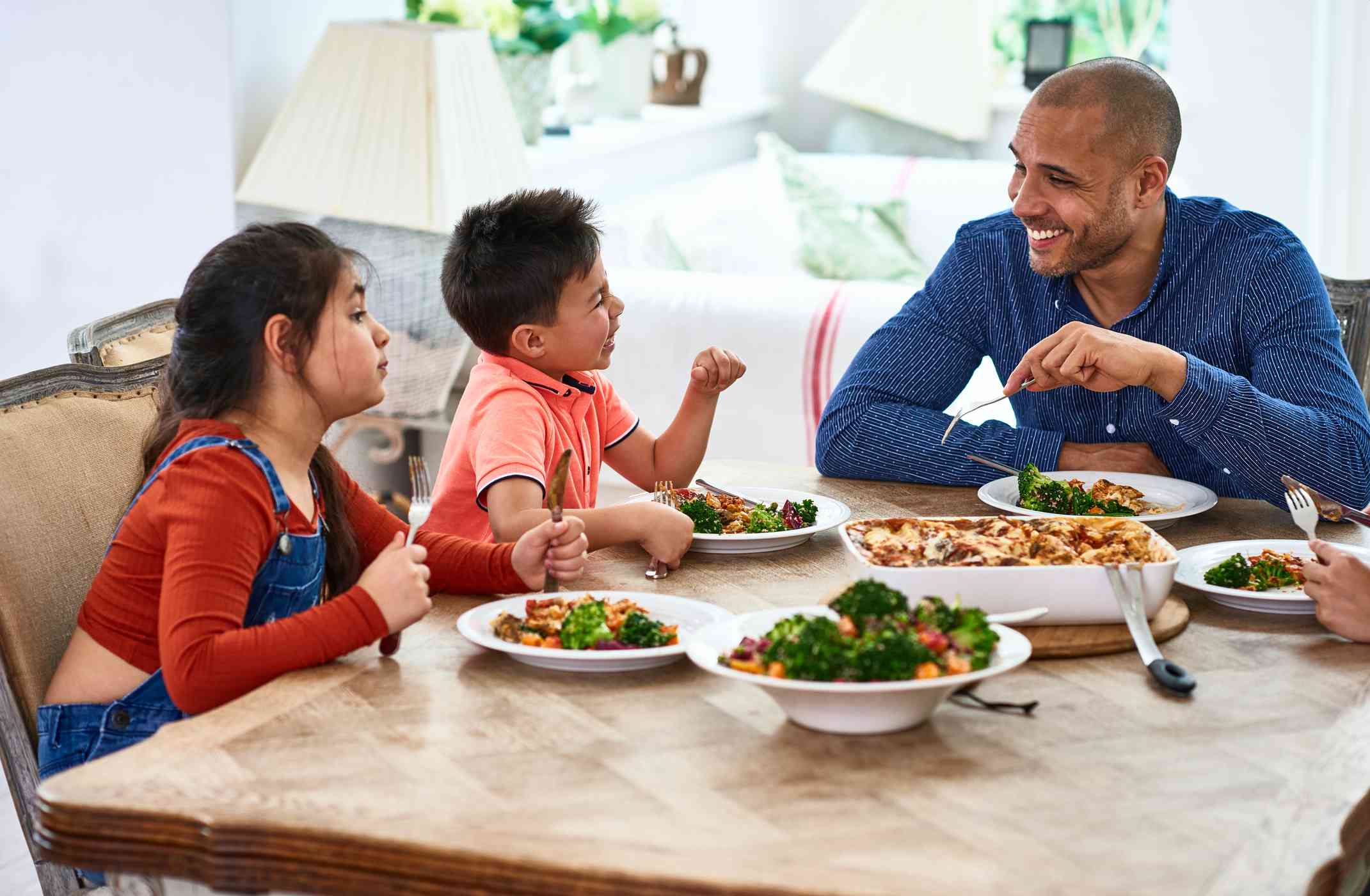 Family enjoying a conversation while eating dinner.