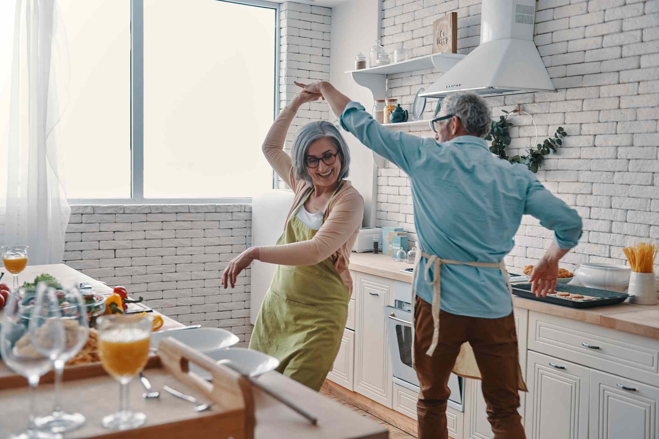 Elderly couple dancing in the kitchen