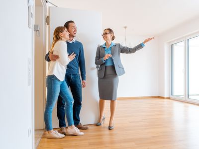 Real Estate Agent showing house to a young couple from a rental listing site