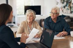 Three people in a meeting in an office