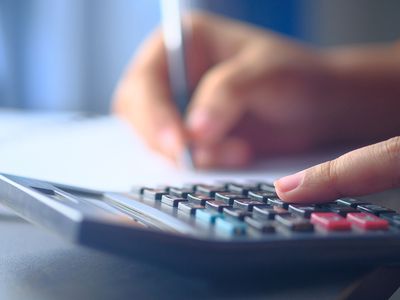 Woman’s Hands Count by Pen and on the Calculator