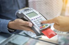 Hand Swiping Credit Card In Store