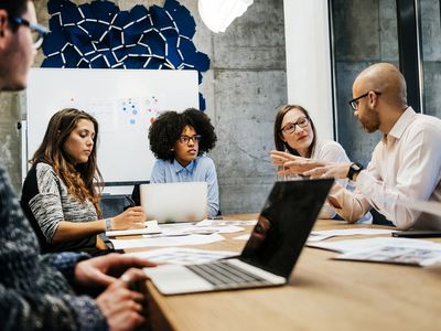 Three Women and Two Men in a Business Meeting