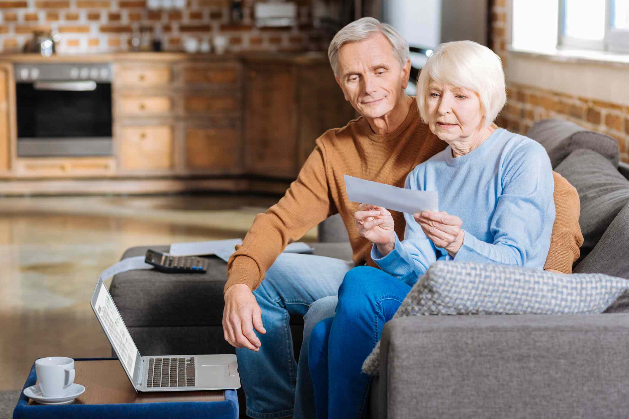 Elderly couple checking financial documents