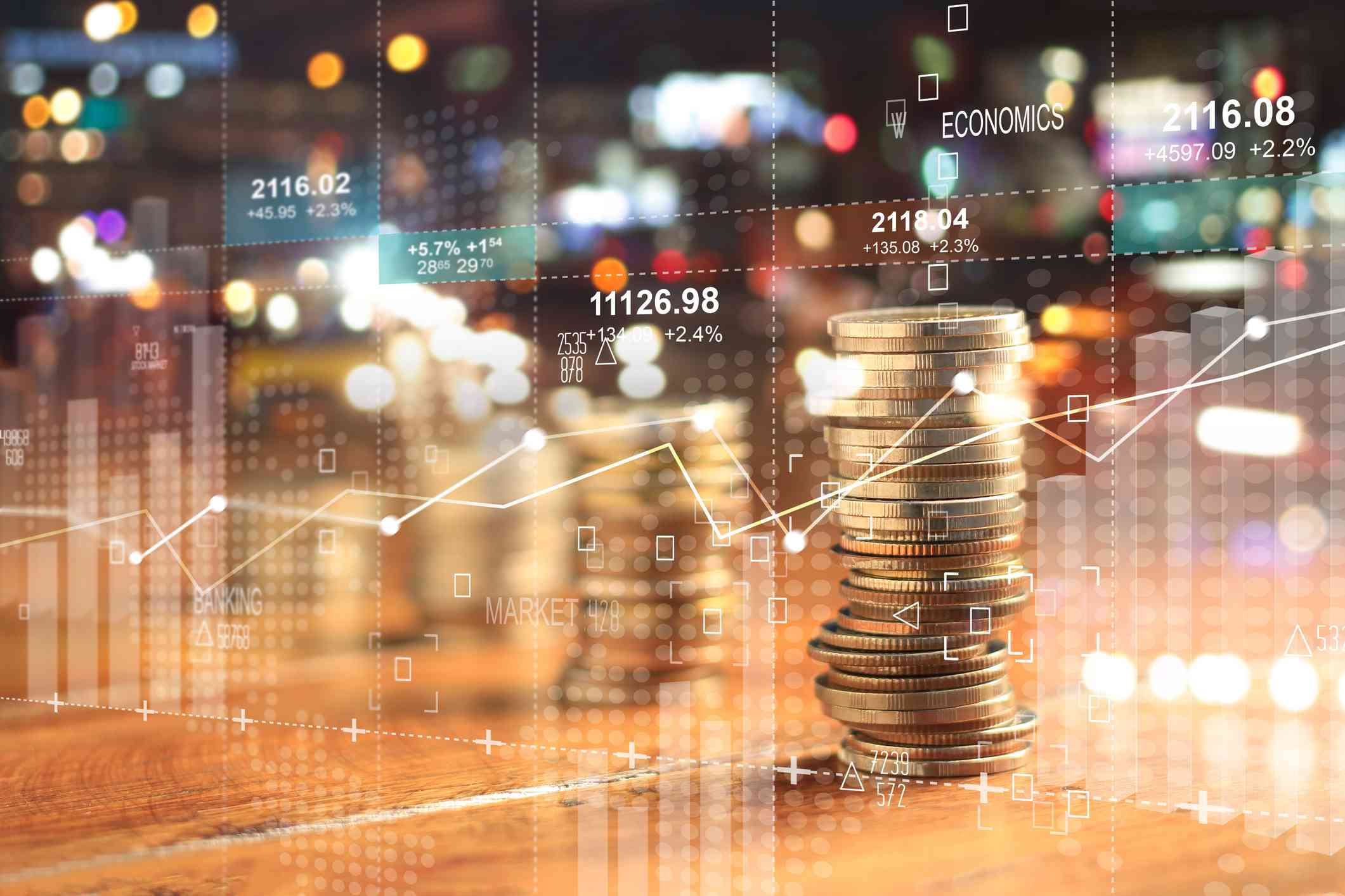 Stack of coins overlaid with financial data and charts