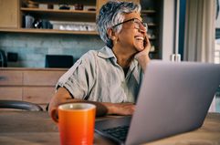 Smiling worker in kitchen with computer