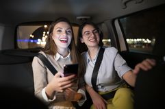 Two passengers sit in a car.