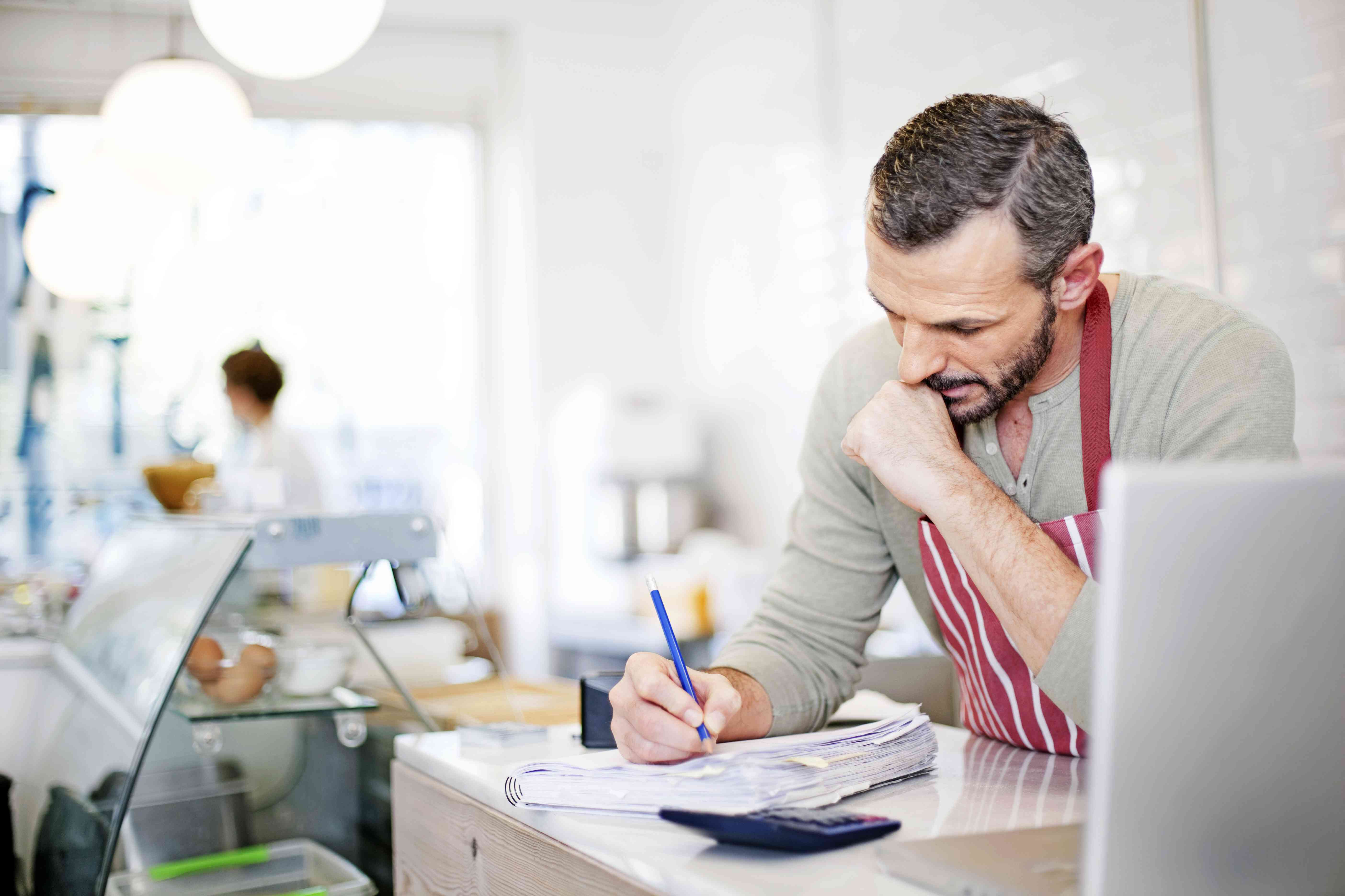 A business owner tallies receipts.