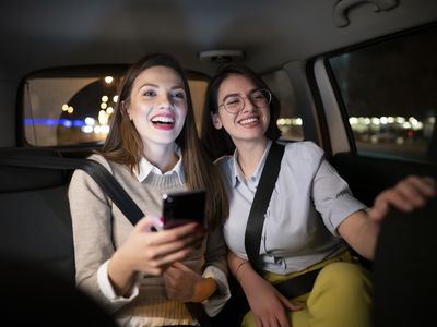 Two passengers sit in a car.