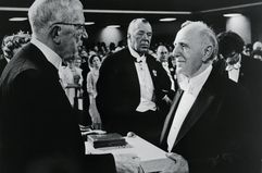 Russian born Simon S. Kuznets, (right) of Harvard University accepts his Nobel Prize in Economics from Sweden's King Gustav Adolf in a Pentecostal church rented for the occasion.