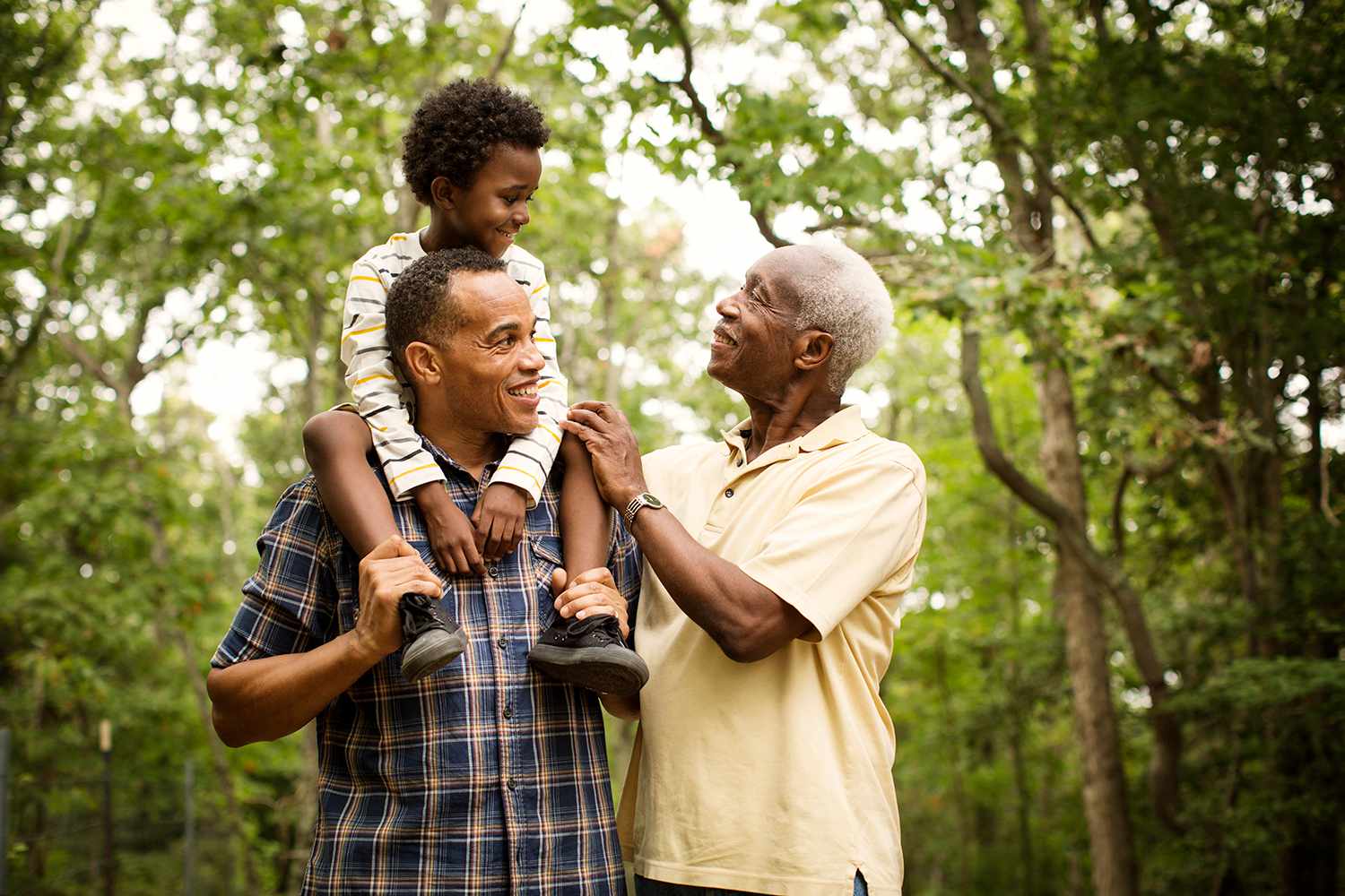 Happy multi-generation family enjoying in forest.