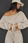 Front view of model posing in the oversized sand french terry Slouchy Pullover Sweatshirt with a wide, off-the-shoulder neckline and a JOAH BROWN logo patch on the right sleeve