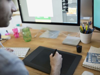 Designer using graphics tablet at computer