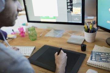 Designer using graphics tablet at computer