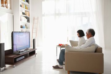 A couple turns off Samsung Voice Assistant on their TV.