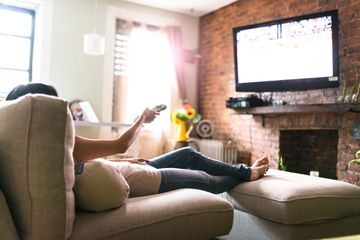 Woman watching TV on couch