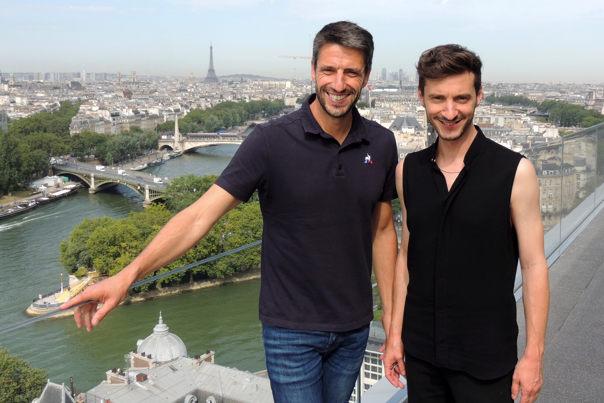 Tony Estanguet, President of the Paris 2024 Olympic and Paralympic Games Organizing Committee, left, poses with Thomas Jolly Friday, July 19, 2024 in Paris. Thomas Jolly, a 40-year-old actor and stage director, was chosen by the Paris 2024 Organizing Committee to helm the artistic direction of the four grand ceremonies. He will be tasked with bringing to life Paris' ambitious plan to hold the July 26, 2024, opening ceremony in the French capital's city center, along the Seine River. (AP Photo/Tom Nouvian)