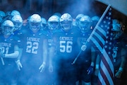 The Cougars line up in the tunnel at the Grand Rapids Catholic Central Athletic Complex during the high school football division 5 regional final game between the Grand Rapids Catholic Central Cougars and the Kalamazoo United Titans Grand Rapids, Mich. on Friday, November 15, 2024. 