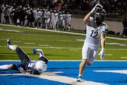 Kalamazoo United junior Keegan McCue (12) scores a touchdown during the high school football division 5 regional final game between the Grand Rapids Catholic Central Cougars and the Kalamazoo United Titans Grand Rapids, Mich. on Friday, November 15, 2024. 