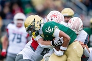 Lumen Christi's Kadale Williams (1) is tackled by Constantine High School's Lucas Stears (80) and Constantine High School's Brody Jones (5) during division six high school football regional final between Constantine and Jackson Lumen Christi at Lumen Christi High School in Jackson on Saturday, Nov. 16, 2024. Lumen Christi won 42-6. 