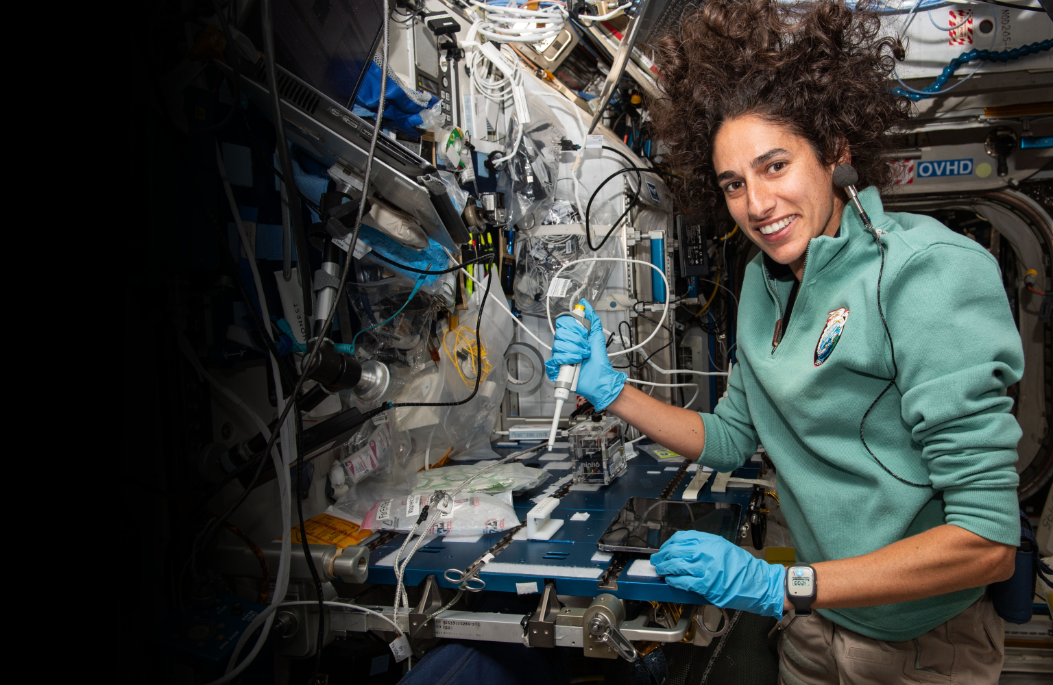 NASA astronaut Jasmin Moghbeli services microbe samples for DNA sequencing aboard the International Space Station.