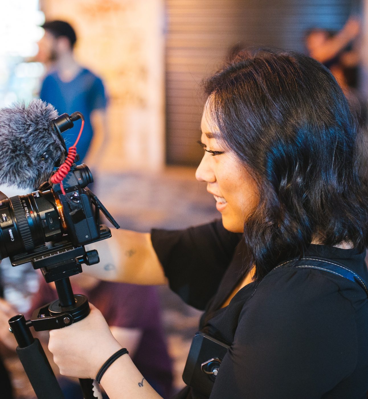 Young woman using DSLR camera