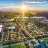 An Aerial view of the Kitchen Garden and The Weston Walled Garden at RHS Bridgewater. The sun shines brightly over neatly organized gardens and buildings.