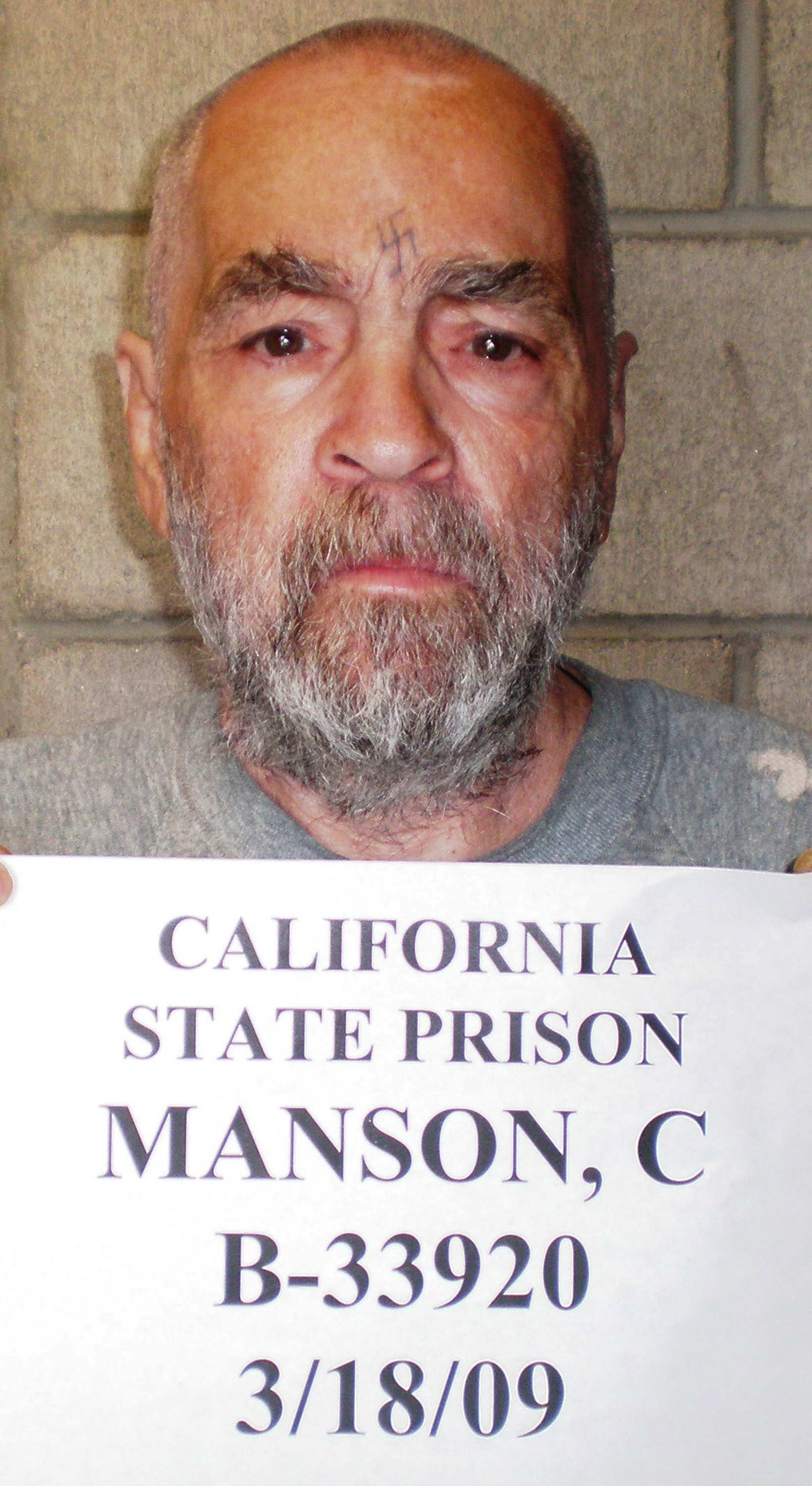 In this handout photo from the California Department of Corrections and Rehabilitation, Charles Manson, 74, is seen March 18, 2009 at Corcoran State Prison, California. Manson is serving a life sentence for conspiring to murder seven people during the "Manson family" killings in 1969. The picture was taken as a regular update of the prison's files. (Handout/California Department of Corrections and Rehabilitation/Getty Images/TNS)