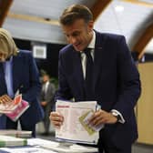 French President Emmanuel Macron and his wife Brigitte Macron prepare to vote during the European election(Hannah McKay/Pool via AP)