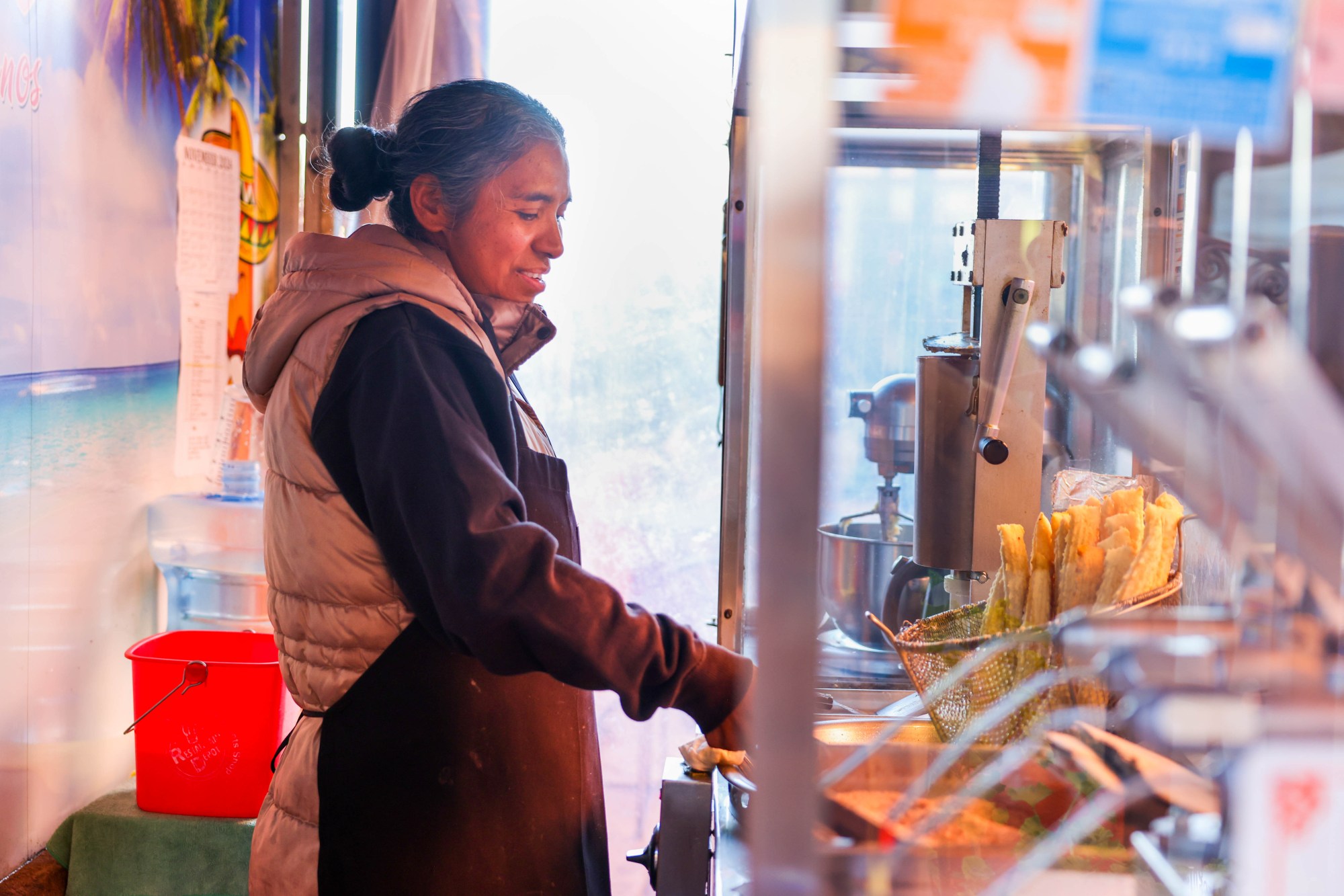 Norma Romero prepares churros from her stand at the Fruitvale Public Market in Oakland, Calif., on Friday, Nov. 15, 2024. (Ray Chavez/Bay Area News Group)