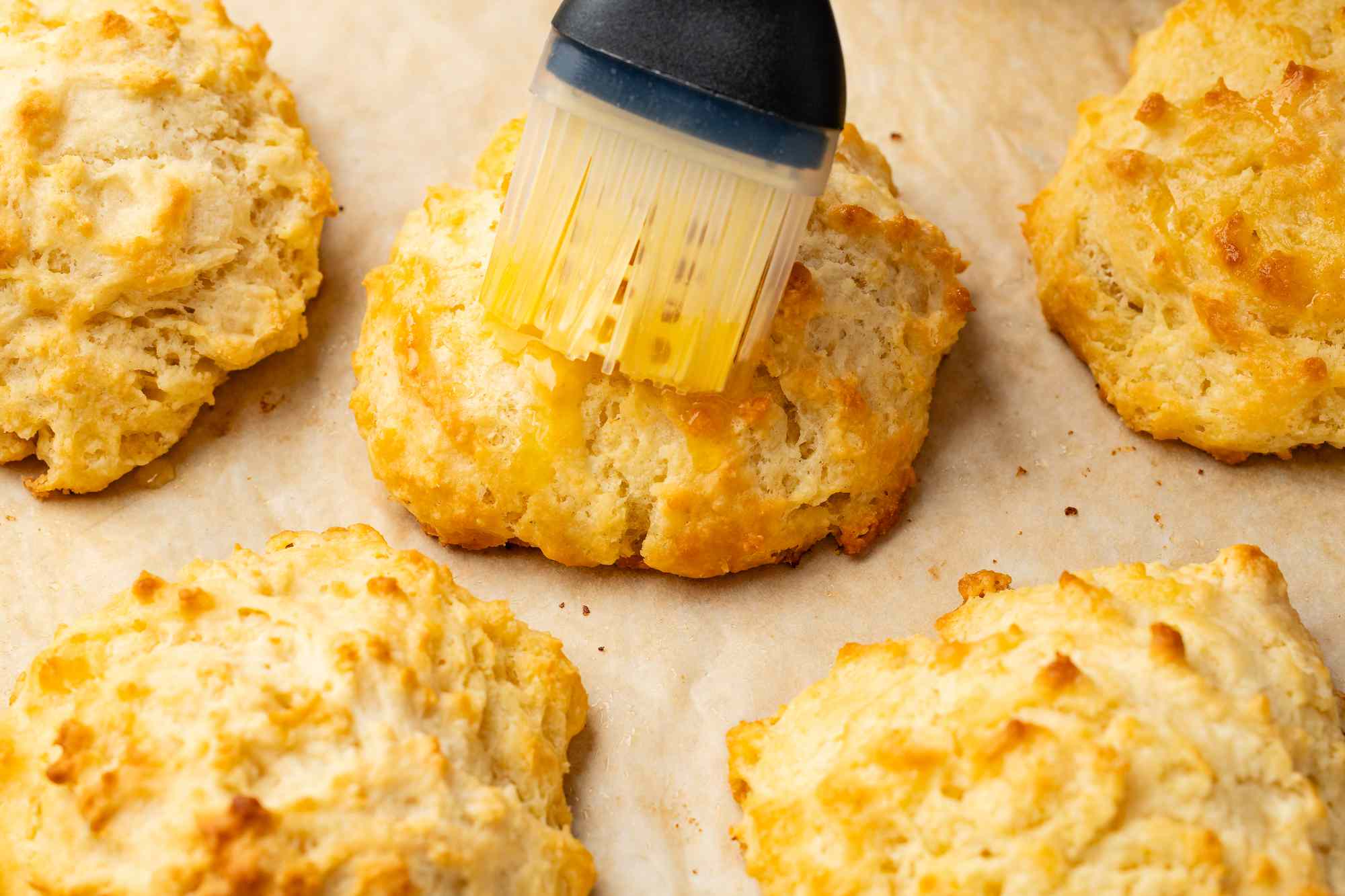 Drop biscuits on a piece of parchment and brushed with butter