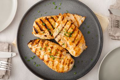 Overhead view of grilled and brined chicken on a plate.