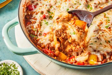 spoonful of unstuffed pepper lifted from skillet with more 