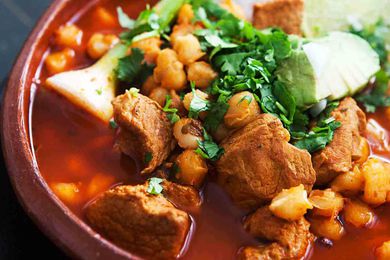 Pork Pozole with Red Chilies in a red bowl