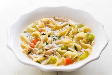 Easy chicken noodle soup in a white bowl.