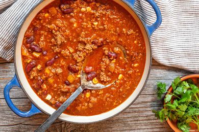 Classic chili in a dutch oven with a serving spoon.